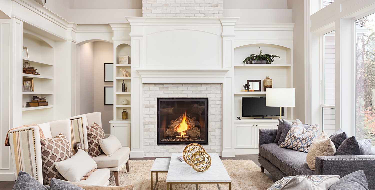 Elegant living room with a lit fireplace and built-in shelving